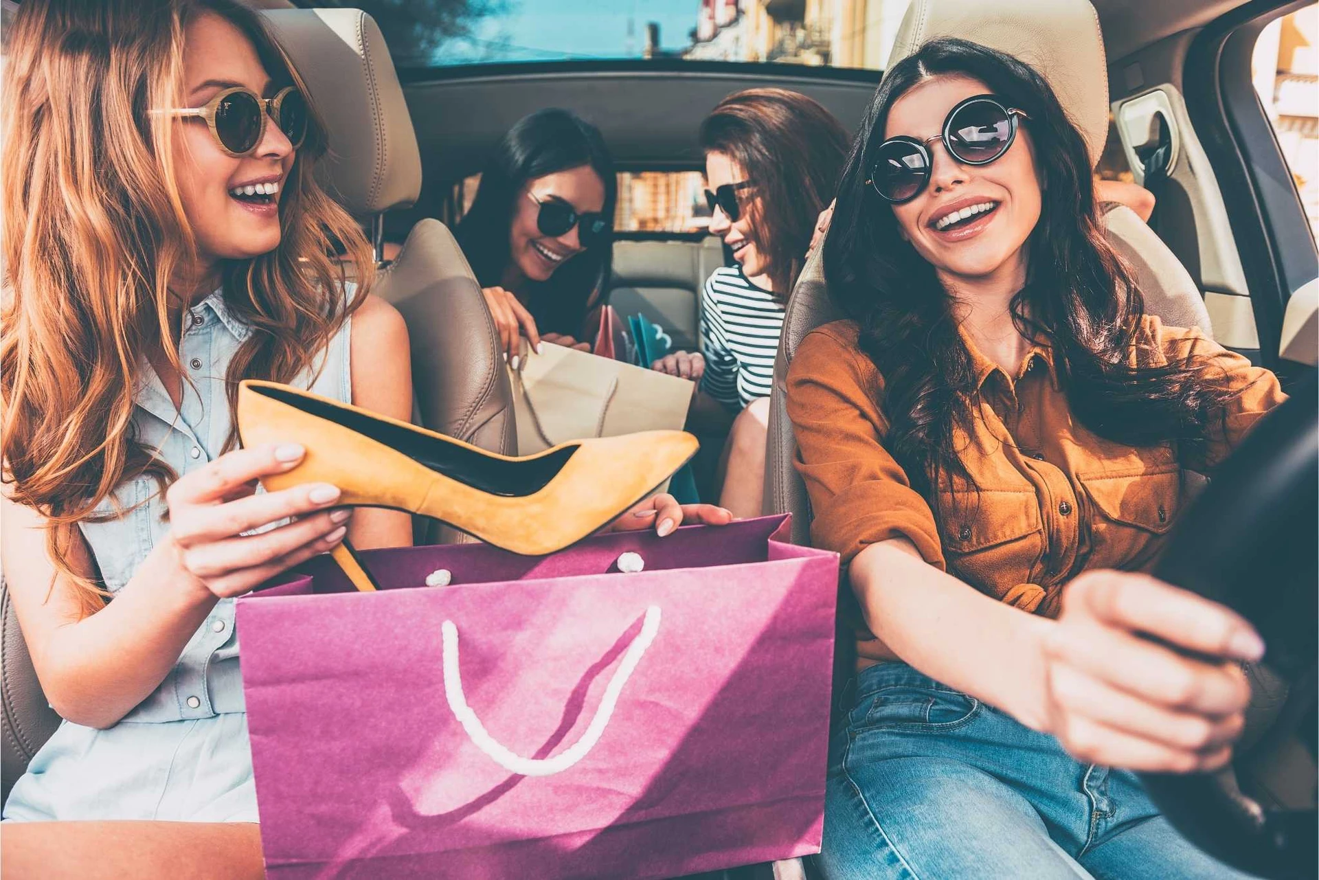 Girls in a car with shopping bags